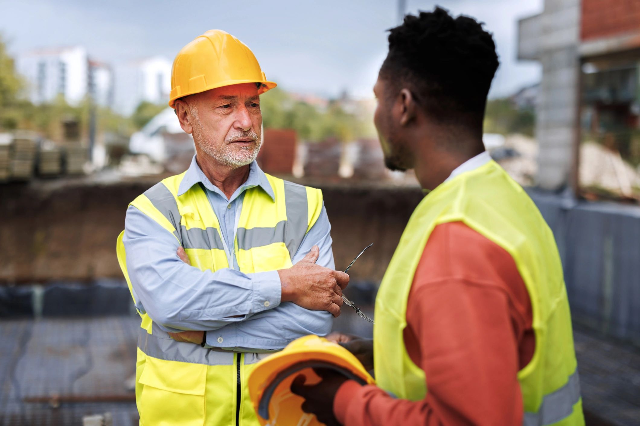 Construction workers discussing work at a site